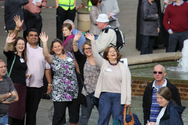 Evangelists in city centre waving to camera