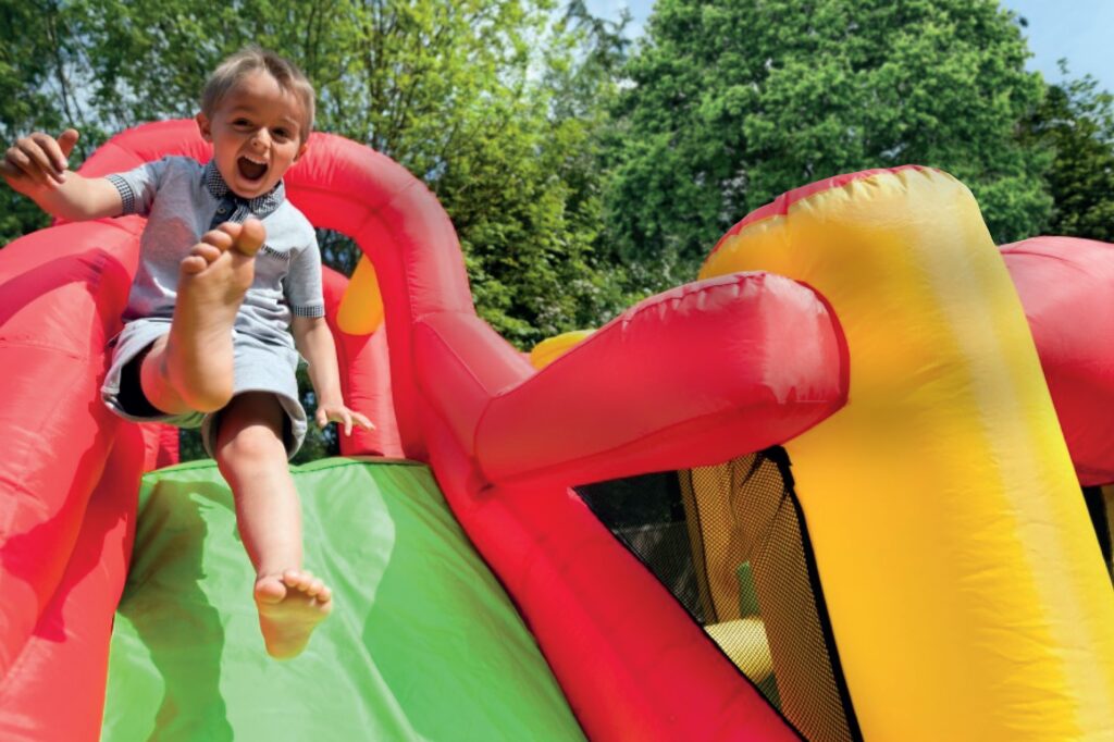 Child on bouncy castle slide