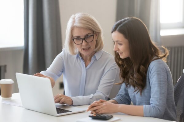 two ladies by a computer screen