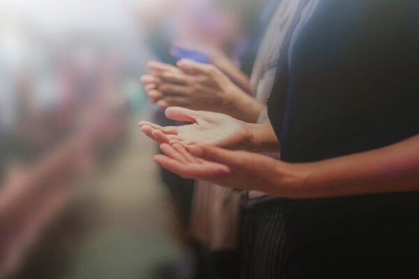 Hands of prayer and worship in church