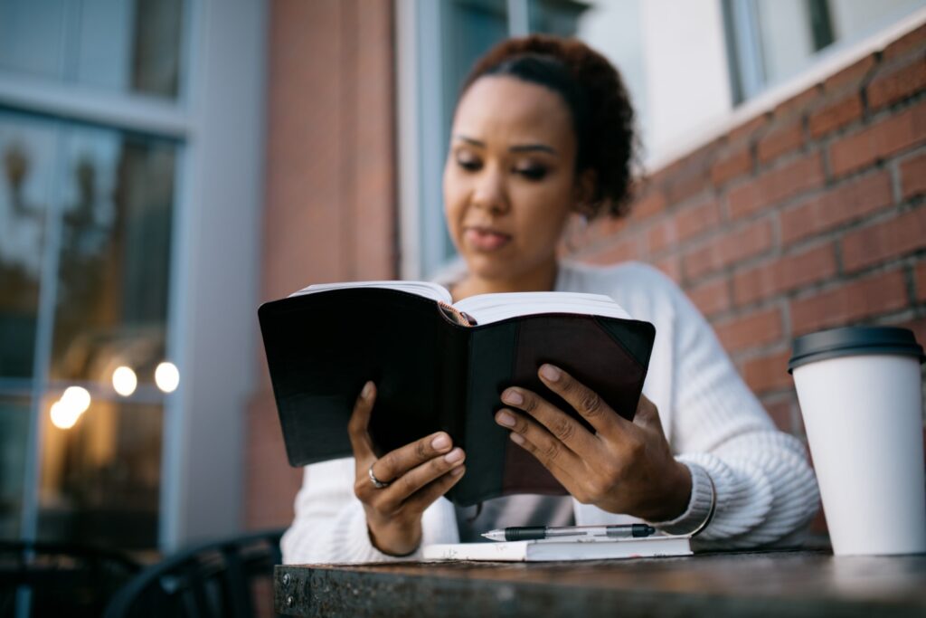 Woman Studying At Outdoor Urban Cafe