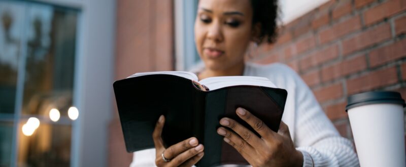 Woman Studying At Outdoor Urban Cafe