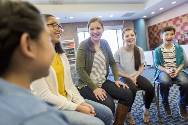 Attentive group of mixed age students participate in a group discussion.