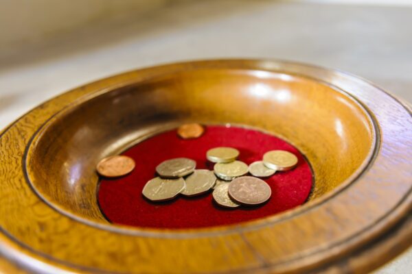 Church collection bowl with some UK Coins