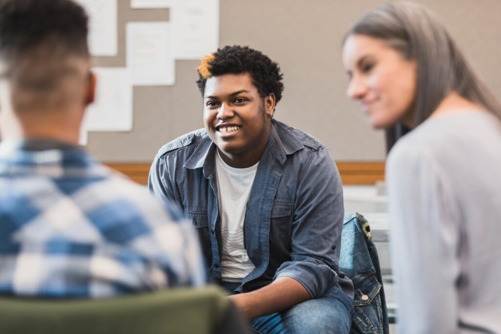 Young people sitting in group talking