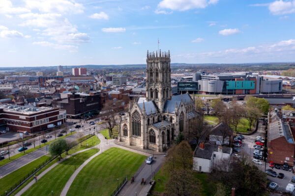 Doncaster, UK - April 15, 2022.  An aerial landscape view of The Minster Church of St George in a  Doncaster town centre cityscape with the Frenchgate centre shopping mall
