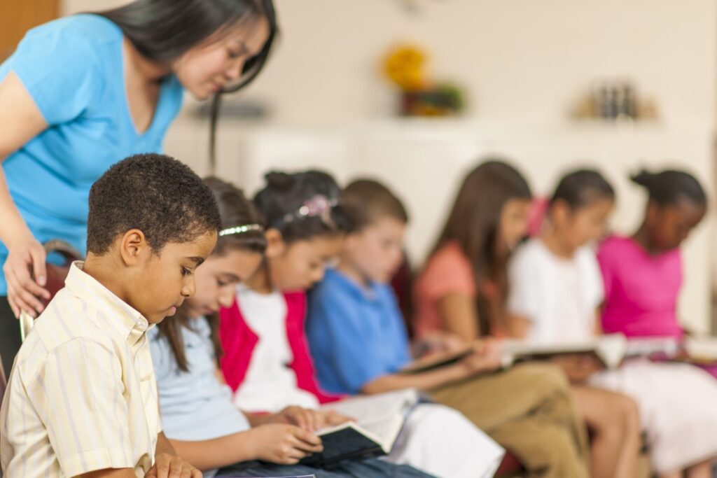 children in classroom with bibles