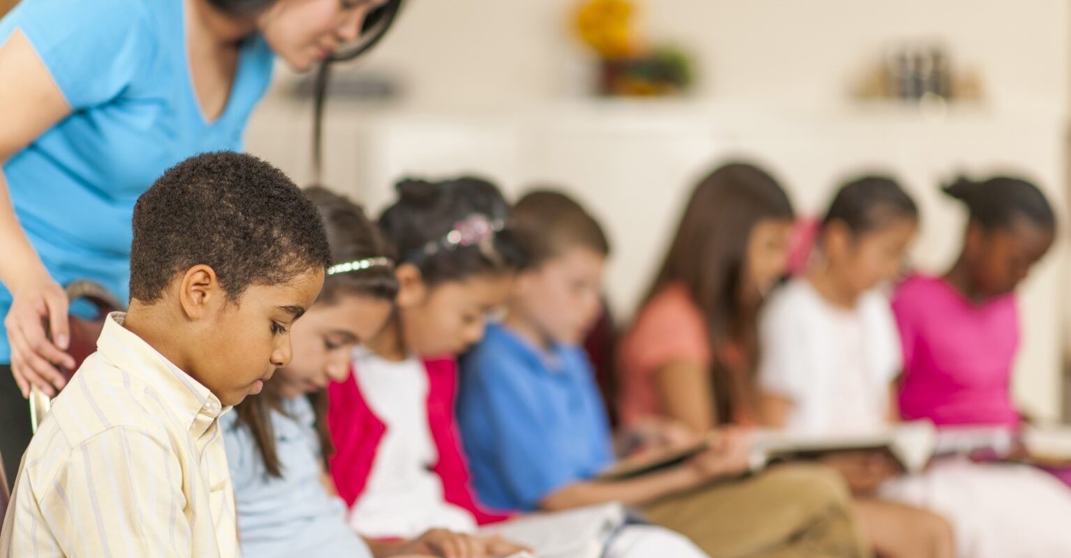 children in classroom with bibles