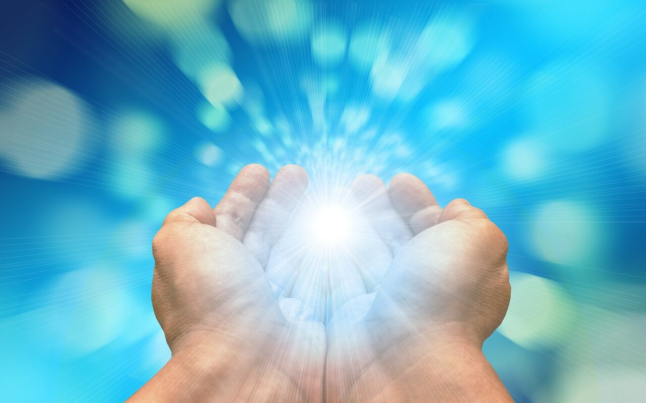 A close-up of hands holding a bright light