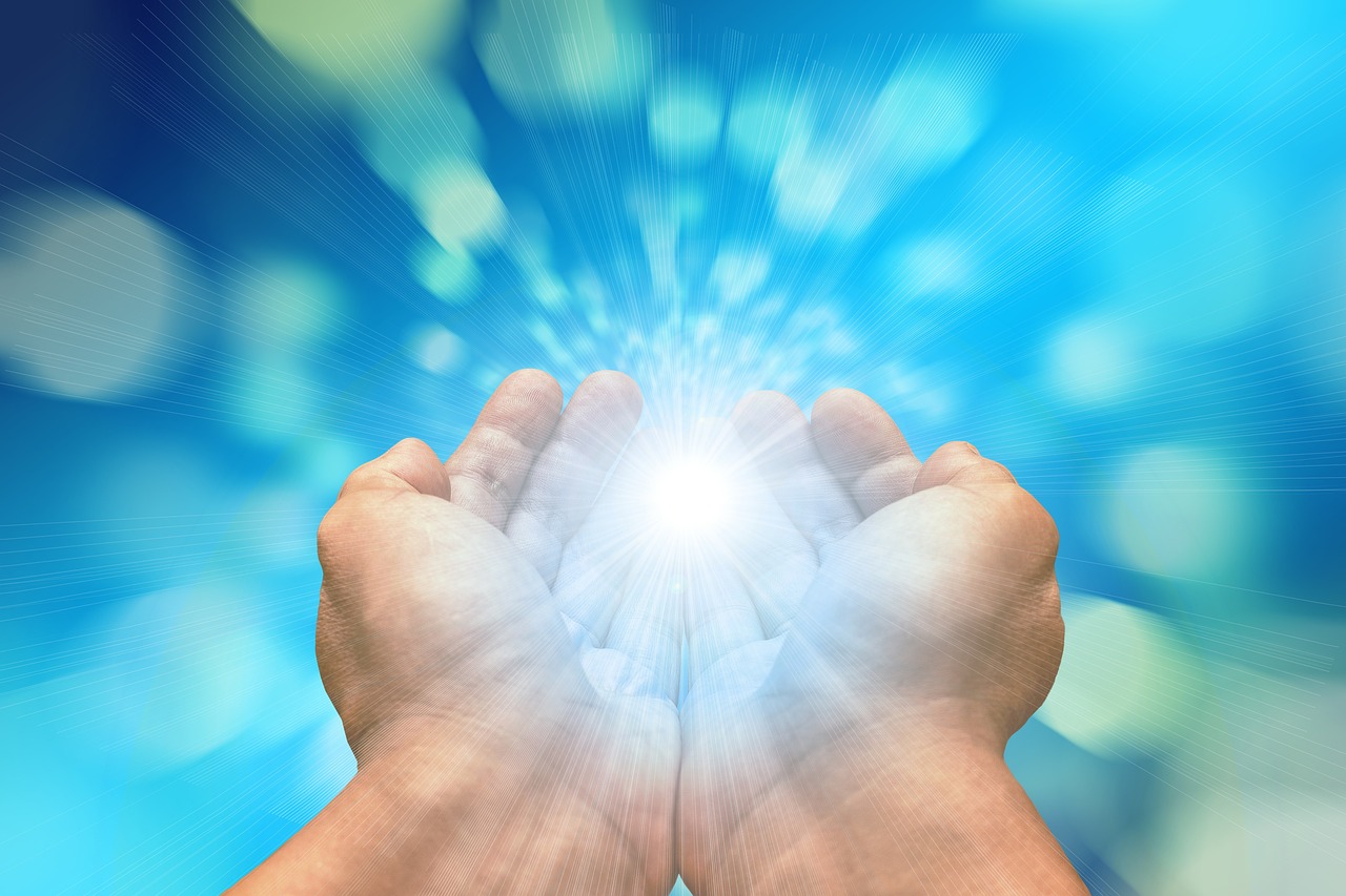 A close-up of hands holding a bright light