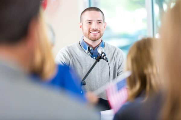 Man speaking into microphone during meeting