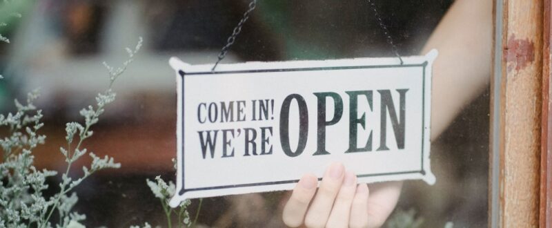 Sign in shop window that reads Come in! We are OPEN