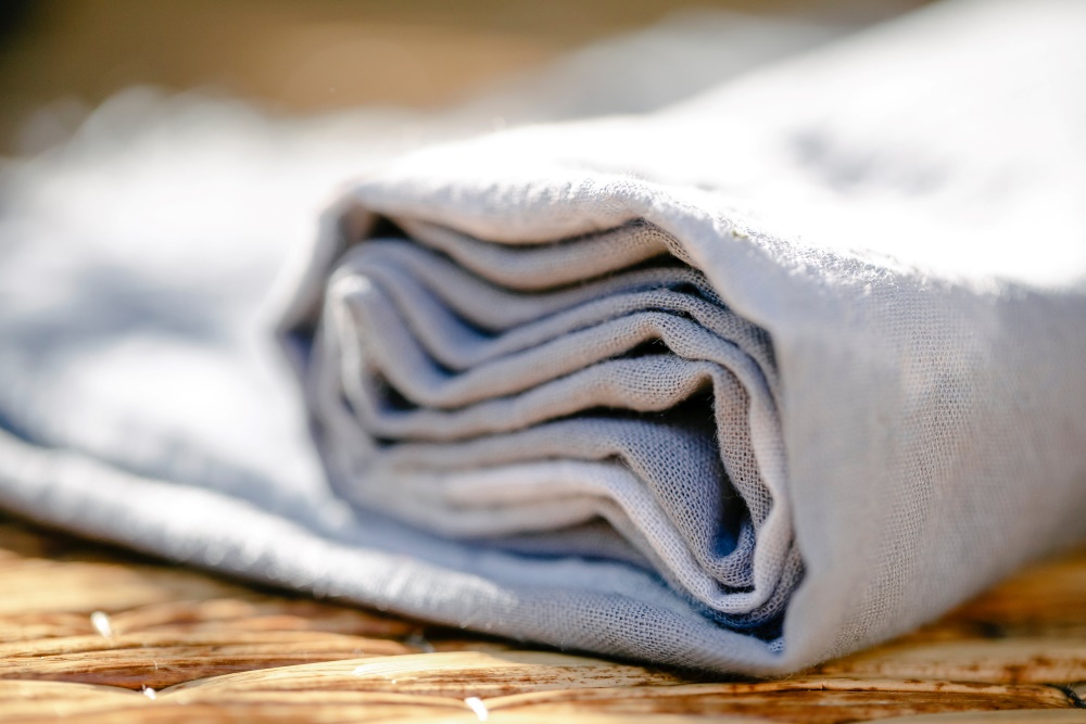 rolled up linen on a wooden surface