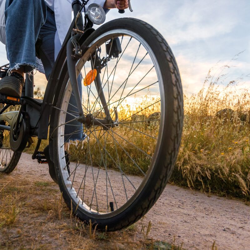 women on a bike in a field. close-up