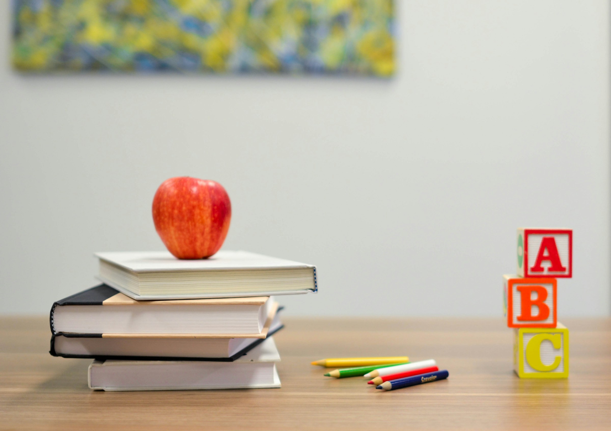 apple balancing on a pile of books