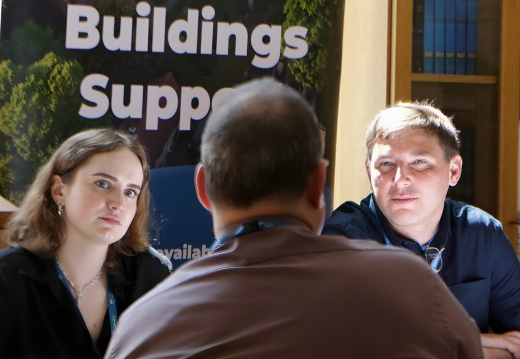 two support officers talking with a churchwarden