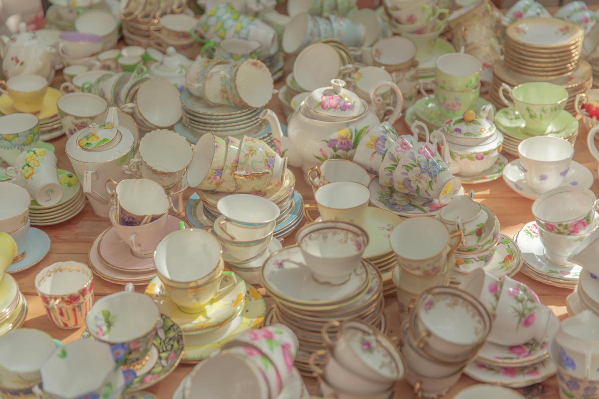 A vibrant assortment of vintage ceramic tea sets with a floral theme, showcasing delicate porcelain craftsmanship